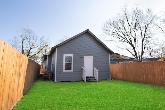 rear view of property with a lawn