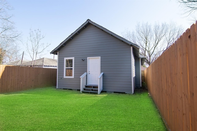 1709 Stevens St, Houston, TX 77026 - back of house featuring entry steps, a fenced backyard, and an outbuilding