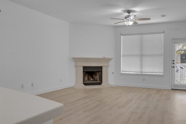 living room featuring ceiling fan and light hardwood / wood-style flooring