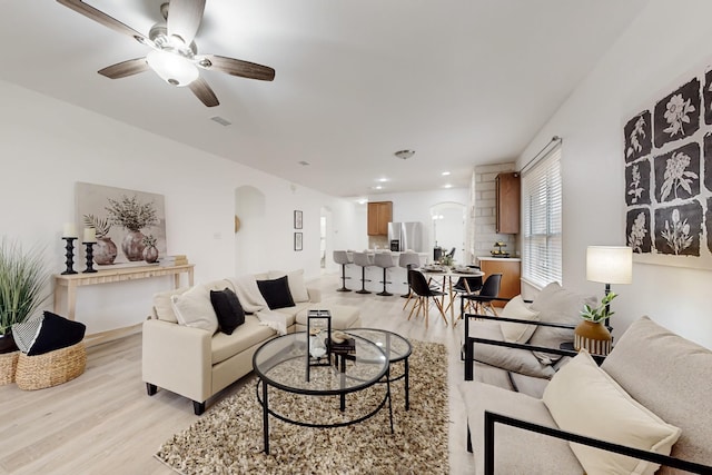 living room featuring light hardwood / wood-style floors and ceiling fan