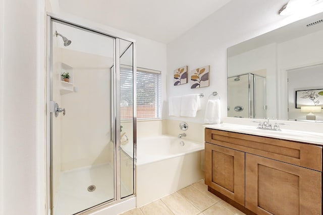 bathroom featuring independent shower and bath, vanity, and tile patterned floors