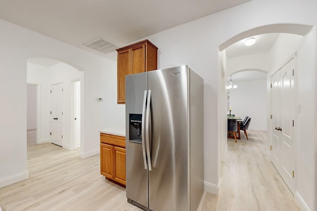 kitchen featuring light hardwood / wood-style floors and stainless steel fridge with ice dispenser