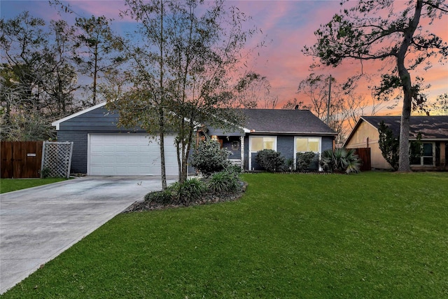 single story home with a yard and a garage