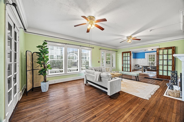 living room featuring dark hardwood / wood-style floors, ornamental molding, a textured ceiling, and french doors