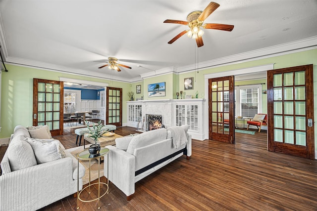 living room featuring dark hardwood / wood-style floors, ceiling fan, ornamental molding, and french doors