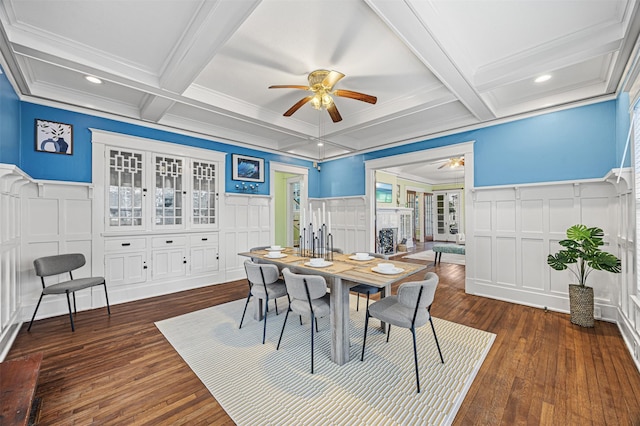 dining space featuring coffered ceiling, dark hardwood / wood-style floors, ceiling fan, ornamental molding, and beamed ceiling