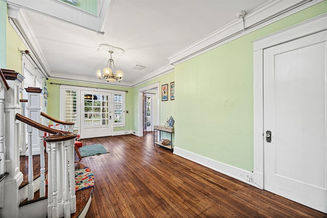 foyer featuring a chandelier, dark hardwood / wood-style floors, and ornamental molding