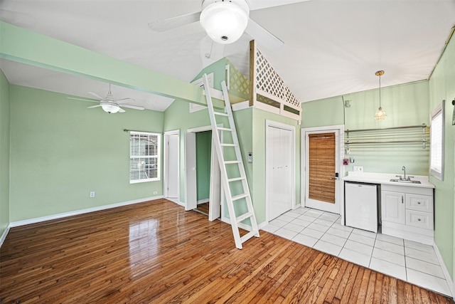 kitchen with ceiling fan, sink, white dishwasher, light hardwood / wood-style floors, and decorative light fixtures