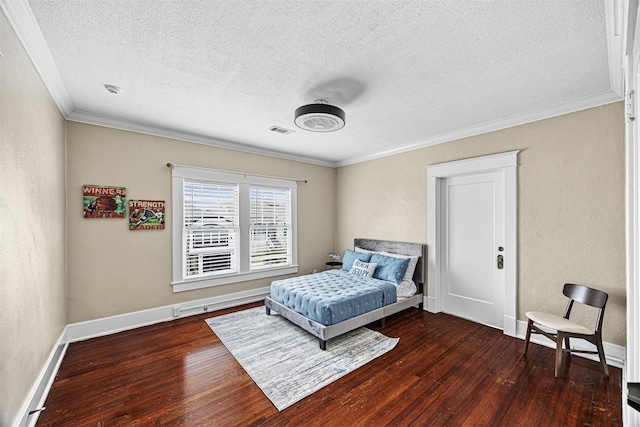 bedroom with ornamental molding, a textured ceiling, and dark wood-type flooring