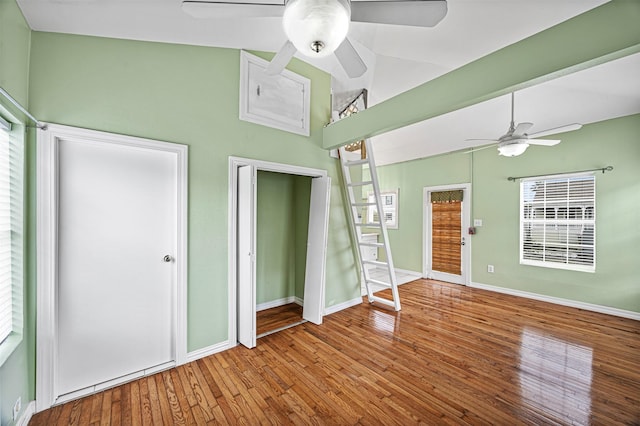 interior space with hardwood / wood-style floors, ceiling fan, and lofted ceiling