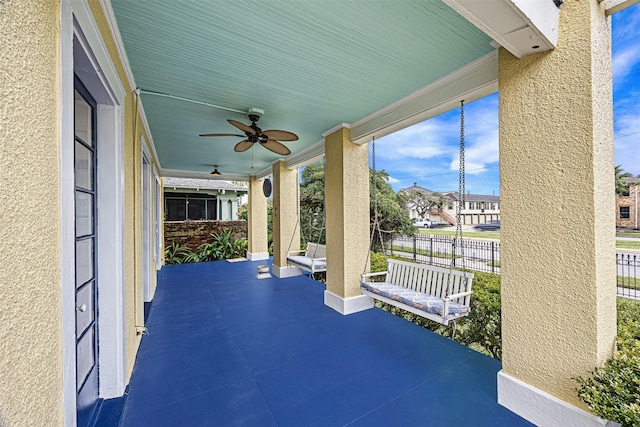 view of patio / terrace with ceiling fan and a porch