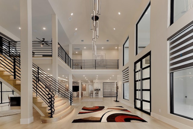 entrance foyer with a high ceiling and ceiling fan