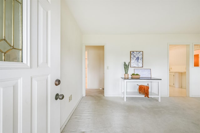 hall featuring light carpet