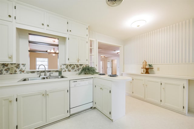 kitchen featuring kitchen peninsula, white cabinetry, dishwasher, and sink