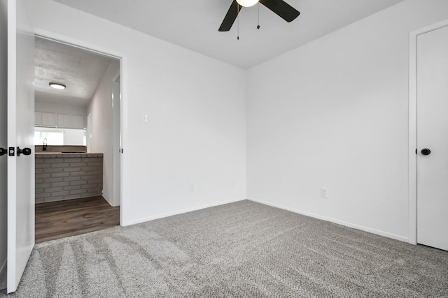 empty room with carpet flooring and ceiling fan