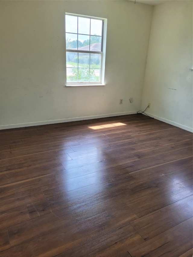 unfurnished room featuring dark wood-type flooring