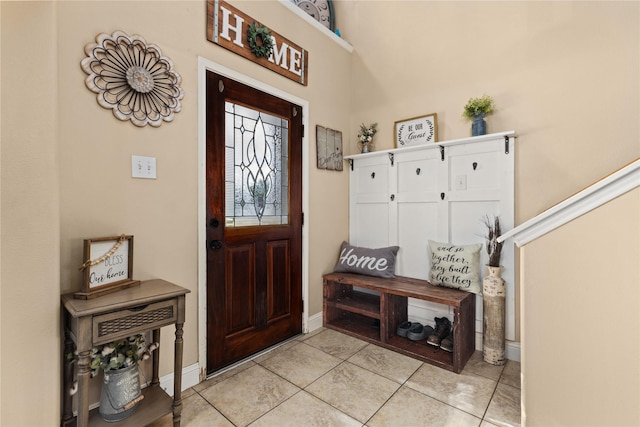 tiled entryway with lofted ceiling