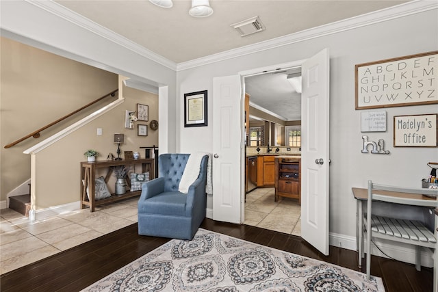 living area with sink, wood-type flooring, and ornamental molding