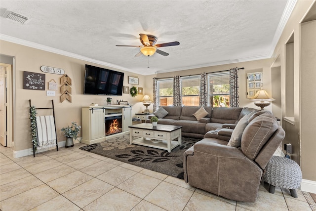 living room featuring light tile patterned floors, a textured ceiling, ceiling fan, and crown molding