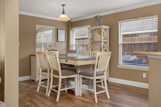 dining space with wood-type flooring and crown molding