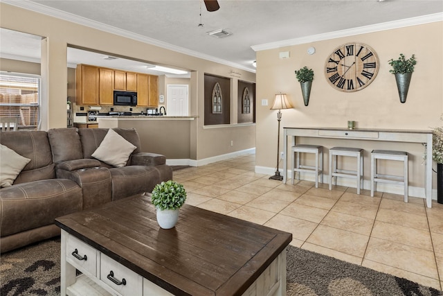 living room featuring crown molding, light tile patterned floors, and ceiling fan