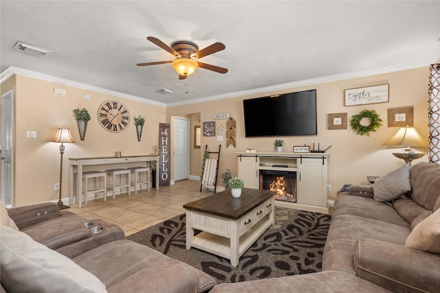 tiled living room with ceiling fan and ornamental molding