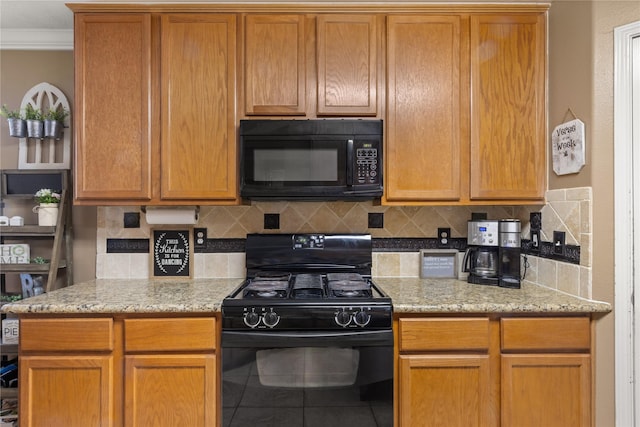 kitchen featuring tasteful backsplash, light stone countertops, and black appliances