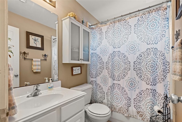 full bathroom with vanity, shower / bath combination with curtain, and toilet