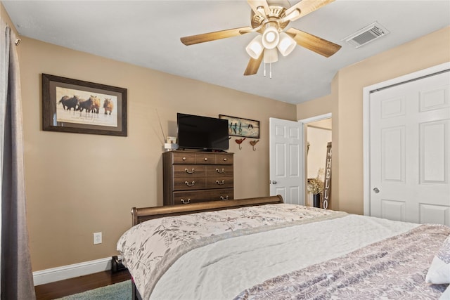 bedroom with a closet, ceiling fan, and dark wood-type flooring