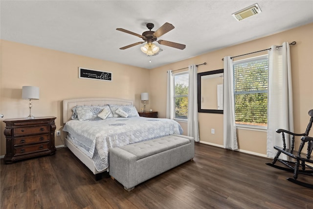 bedroom with dark hardwood / wood-style floors and ceiling fan