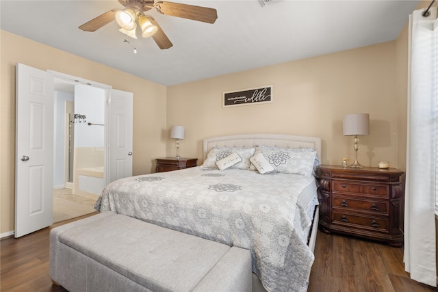 bedroom featuring ceiling fan, dark hardwood / wood-style flooring, and ensuite bathroom