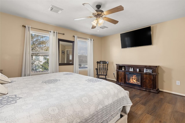 bedroom with ceiling fan and dark hardwood / wood-style flooring