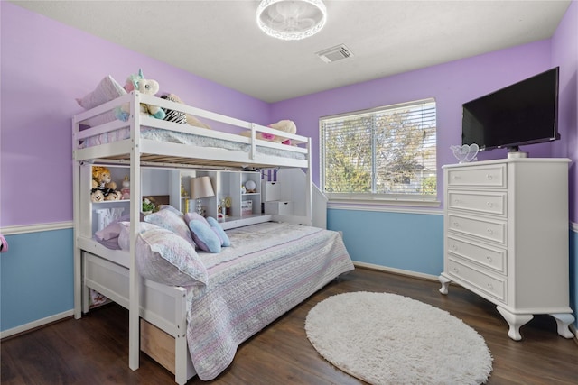 bedroom with dark hardwood / wood-style floors