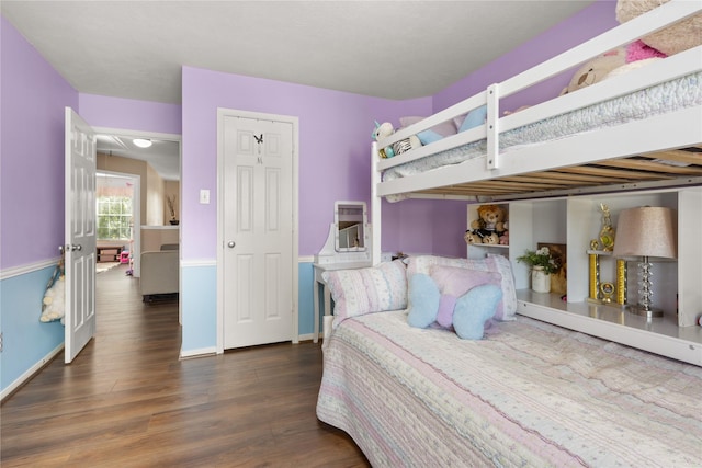 bedroom with dark wood-type flooring