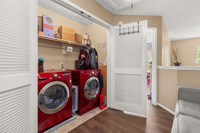 clothes washing area with hardwood / wood-style flooring and independent washer and dryer