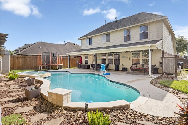 view of swimming pool with an in ground hot tub, a patio, an outdoor living space, and a trampoline