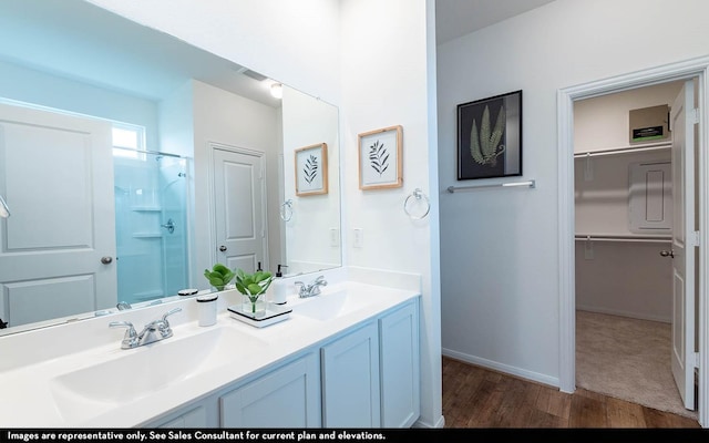 bathroom with vanity, an enclosed shower, and wood-type flooring