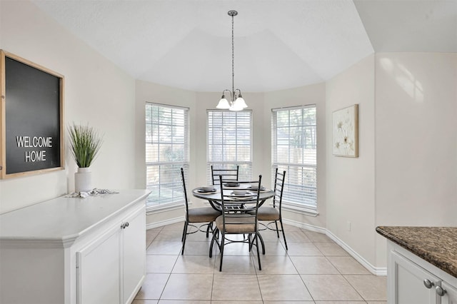 dining space with vaulted ceiling, a wealth of natural light, and light tile patterned flooring