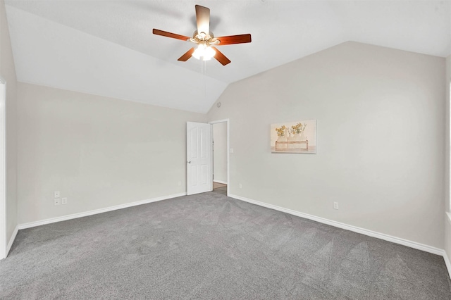 unfurnished room featuring dark carpet, vaulted ceiling, and ceiling fan