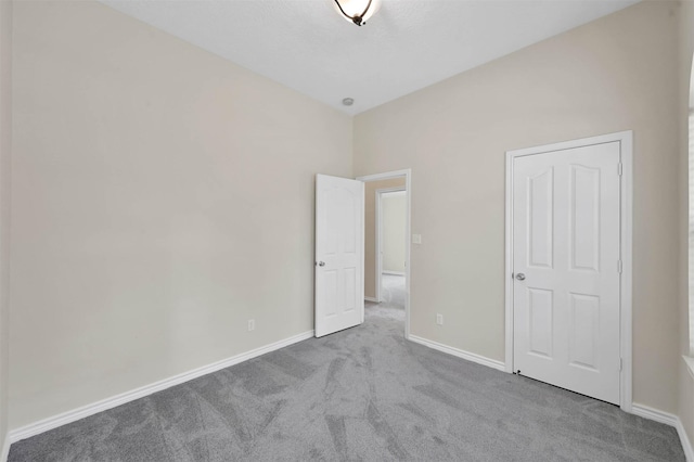 unfurnished bedroom with light colored carpet