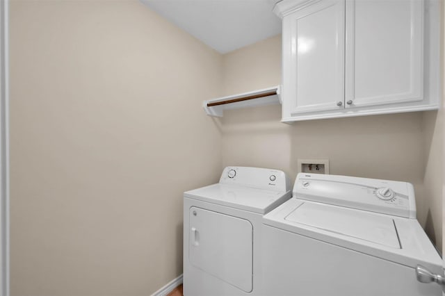 laundry area with washer and dryer and cabinets