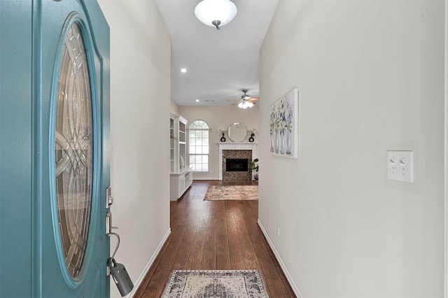 foyer with ceiling fan and dark wood-type flooring