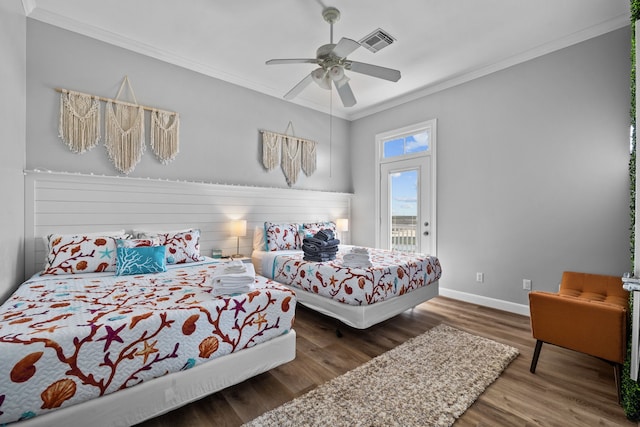 bedroom featuring hardwood / wood-style floors, ceiling fan, and crown molding