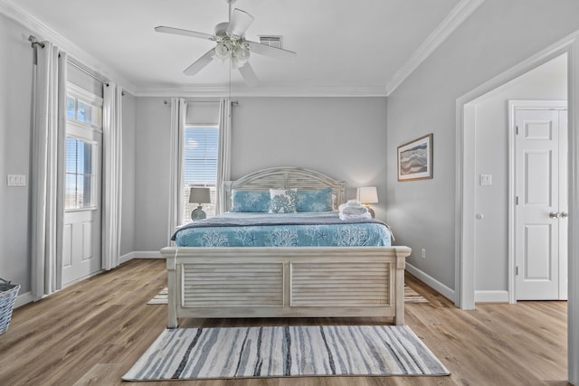 bedroom featuring ceiling fan, light wood-type flooring, and multiple windows