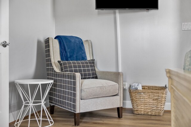 sitting room with wood-type flooring