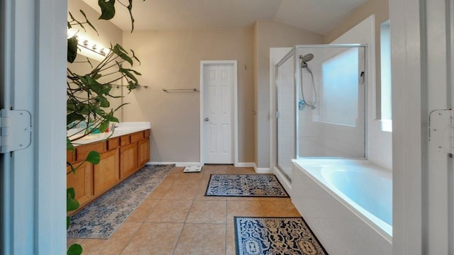 bathroom with vaulted ceiling, vanity, separate shower and tub, and tile patterned flooring