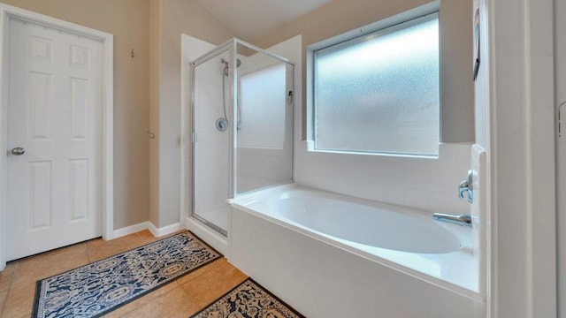 bathroom with independent shower and bath and tile patterned flooring