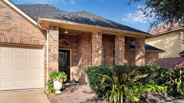 doorway to property with a garage