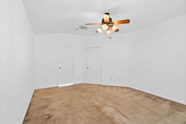 spare room featuring carpet flooring, ceiling fan, and lofted ceiling