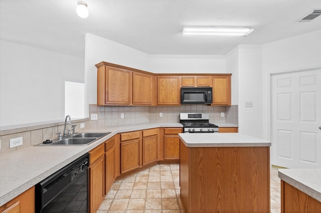 kitchen with sink, backsplash, a kitchen island, and black appliances